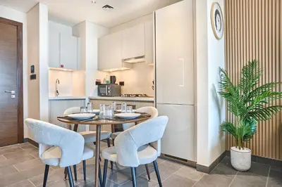a kitchen and dining room with a table and chairs at STAY BY LATINEM Luxury 1BR Holiday Home CB 0919 Near Burj Khalifa in Dubai
