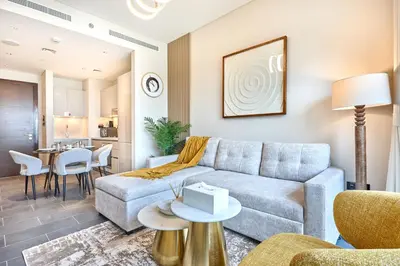 a living room with a couch and a table at STAY BY LATINEM Luxury 1BR Holiday Home CB 0919 Near Burj Khalifa in Dubai