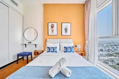 a bedroom with a bed and a large window at 1BR in Collective With Pool, Gym and CoWorking Space in Dubai