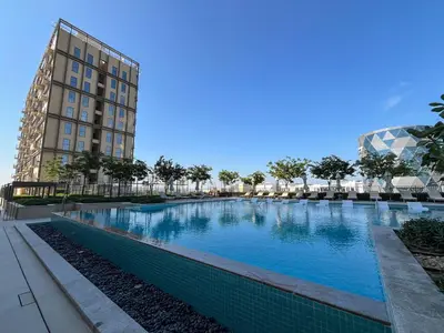 a large swimming pool in front of a building at 1BR in Collective With Pool, Gym and CoWorking Space in Dubai