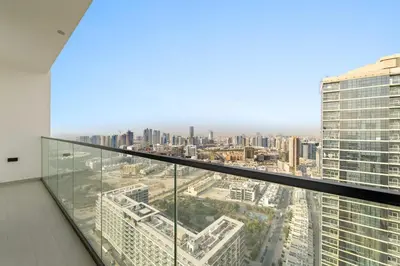 a view of a city from the top of a building at Stylish 2BR JVC with Pool, Gym Access, and City Skyline Views in Dubai