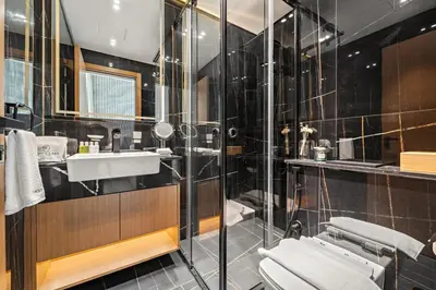 a bathroom with a sink and a shower at Stylish 2BR JVC with Pool, Gym Access, and City Skyline Views in Dubai