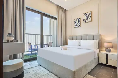 a hotel room with a bed and a balcony at STAY BY LATINEM Luxury 1BR Holiday Home CB 3015 Near Burj Khalifa in Dubai