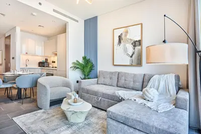 a living room with a couch and a table at STAY BY LATINEM Luxury 1BR Holiday Home CB 3015 Near Burj Khalifa in Dubai