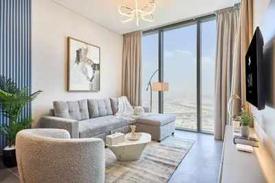 a living room with a couch and chairs and windows at STAY BY LATINEM Luxury 1BR Holiday Home CB 3015 Near Burj Khalifa in Dubai
