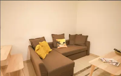 a living room with a brown couch and a table at Sobha Creek Vistas Reserve, Sobha Hartland, Dubai in Dubai