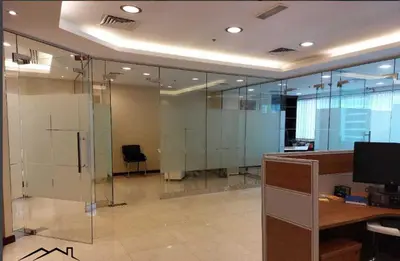 an office with glass walls and a desk with a computer at Sobha Creek Vistas Reserve, Sobha Hartland, Dubai in Dubai