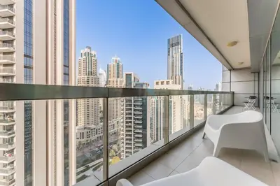 an apartment balcony with a view of a city at Apartment near Burj Khalifa and Dubai Mall, Central Location, Minutes to Dubai Marina and Palm Jumeirah - 8 BLVD Walk, Downtown Dubai by Deluxe Holiday Homes in Dubai