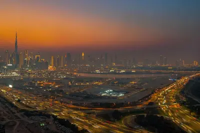 a view of a city at night with traffic at FIRST CLASS 4BR Sobha Skyline Luxury in Dubai