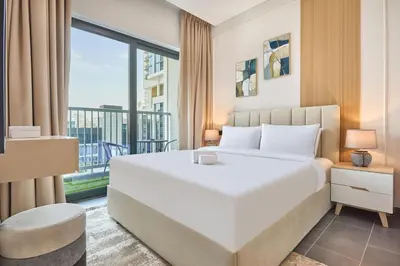 a bedroom with a large white bed and a large window at STAY BY LATINEM Luxury 1BR Holiday Home CB 0902 Near Burj Khalifa in Dubai