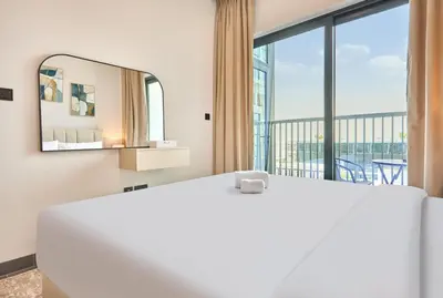 a bedroom with a large bed and a large window at STAY BY LATINEM Luxury 1BR Holiday Home CB 0902 Near Burj Khalifa in Dubai
