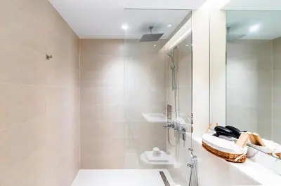 a bathroom with a shower and a sink at Stylish Apartment in La Mer Dubai in Dubai