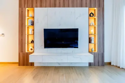 a living room with a television on a white wall at Stylish Apartment in La Mer Dubai in Dubai