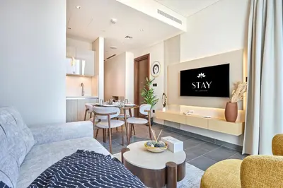 a living room with a couch and a tv at STAY BY LATINEM Luxury 1BR Holiday Home CB 1409 Near Burj Khalifa in Dubai