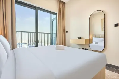 a bedroom with a large bed and a mirror at STAY BY LATINEM Luxury 1BR Holiday Home CB 1409 Near Burj Khalifa in Dubai