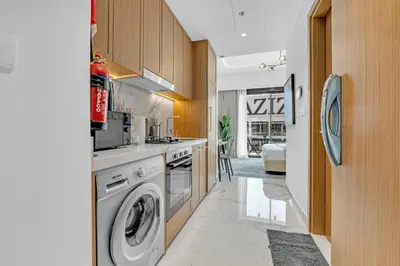 a kitchen with a washer and dryer at Chic Dubai Retreat at Azizi Riviera 65 in Dubai