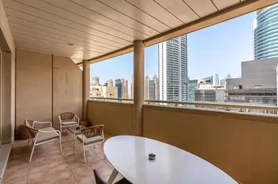 a room with a table and chairs and a large window at Retro 1BR APT in Marina Near JBR Beach & Mall in Dubai
