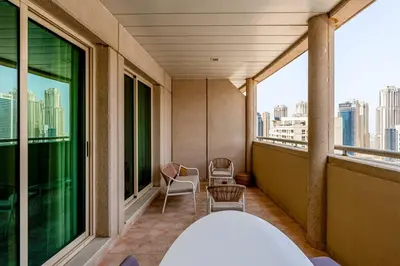 a balcony with chairs and a view of the city at Retro 1BR APT in Marina Near JBR Beach & Mall in Dubai