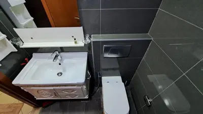 a small bathroom with a sink and a toilet at DRUVYA HOLIDAY HOMES, Marina Diamond 1, Close to Sobha Realty Metro 3 min walkable in Dubai