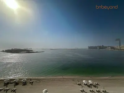 a beach with a group of umbrellas on the beach at Exclusive Home with Private Beach in Dubai