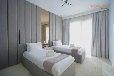 a hotel room with two beds and a window at Exclusive Home with Private Beach in Dubai