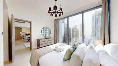a bedroom with a white bed and a large window at Vacationer l Urban Luxe 1 Bedroom l with Marina Views in Dubai
