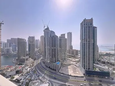 a city with many tall buildings and a freeway at Vacationer l Urban Luxe 1 Bedroom l with Marina Views in Dubai