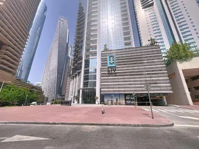 a building in the middle of a city with tall buildings at Vacationer l Urban Luxe 1 Bedroom l with Marina Views in Dubai
