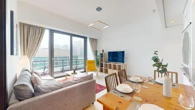 a living room with a couch and a table at Vacationer l Bright 1 Bedroom l near Marina Promenade in Dubai