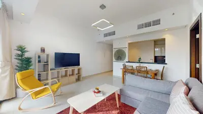 a living room with a couch and a tv at Vacationer l Bright 1 Bedroom l near Marina Promenade in Dubai
