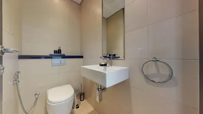 a bathroom with a sink and a toilet and a mirror at Vacationer l Bright 1 Bedroom l near Marina Promenade in Dubai