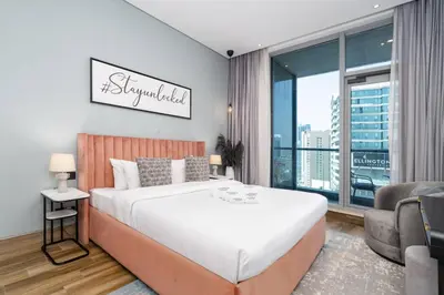 a bedroom with a large bed and a large window at Contemporary Business Bay 1-Bed with City Views in Dubai