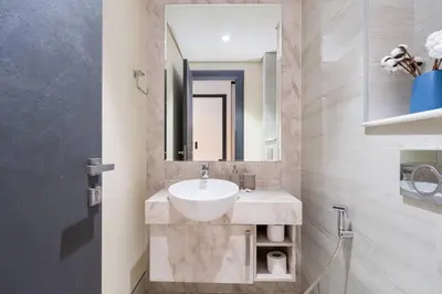 a bathroom with a sink and a mirror at Contemporary Business Bay 1-Bed with City Views in Dubai