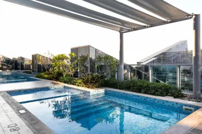 a swimming pool on the roof of a building at Contemporary Business Bay 1-Bed with City Views in Dubai