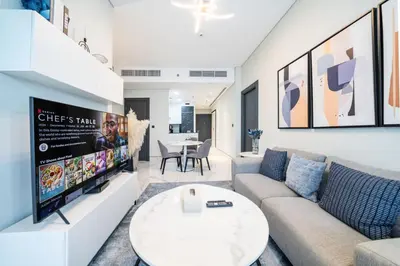 a living room with a couch and a tv at Contemporary Business Bay 1-Bed with City Views in Dubai