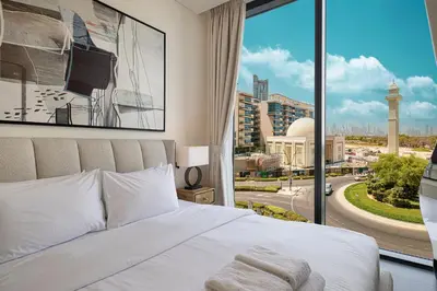 a bedroom with a bed and a large window at Moon Stays - Opulent 2BR Stay - Sobha Hartland in Dubai