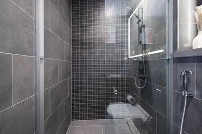 a bathroom with a shower with a glass door at Moon Stays - Opulent 2BR Stay - Sobha Hartland in Dubai