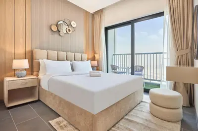 a bedroom with a large white bed and a balcony at STAY BY LATINEM Luxury 1BR Holiday Home CB 3503 Near Downtown in Dubai