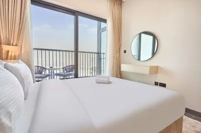 a bedroom with a large bed and a large window at STAY BY LATINEM Luxury 1BR Holiday Home CB 3503 Near Downtown in Dubai