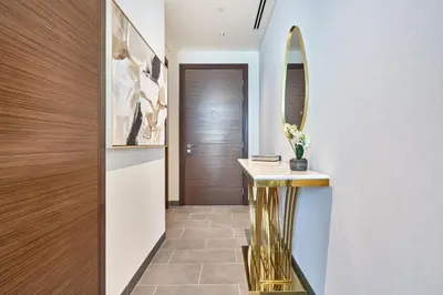 a hallway with a mirror and a console table at STAY BY LATINEM Luxury 1BR Holiday Home CB 3503 Near Downtown in Dubai