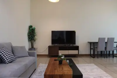 a living room with a couch and a tv at Spacious 1 BR in Sulafa Tower in Dubai