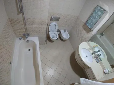 a bathroom with a tub and a toilet and a sink at Spacious 1 BR in Sulafa Tower in Dubai
