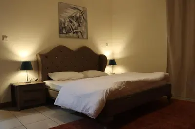 a bedroom with a bed with a headboard and a table at Spacious 1 BR in Sulafa Tower in Dubai