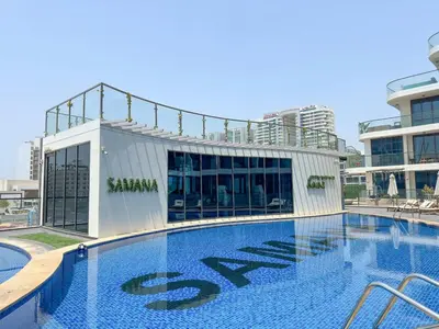 a large swimming pool in front of a building at Elegant 2BR Apartment Private Pool by Czechin in Dubai