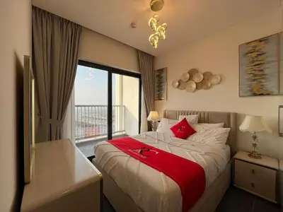 a bedroom with a bed with a large window at The Crest Sobha Hartland in Dubai
