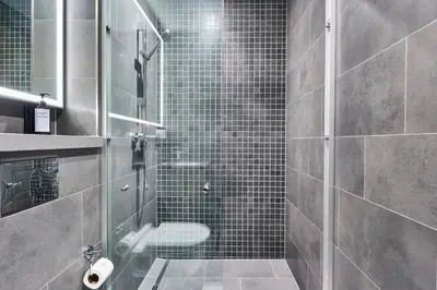 a bathroom with a glass shower with a toilet at STAY BY LATINEM Luxury 1BR Holiday Home CB1508 Near Burj Khalifa in Dubai