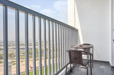 a balcony with a table and chair on a building at STAY BY LATINEM Luxury 1BR Holiday Home CB1508 Near Burj Khalifa in Dubai