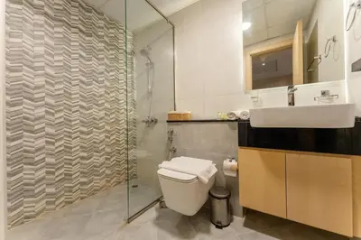 a bathroom with a toilet and a sink and a shower at Cosy 2 Bed Apartment in Al Jaddaf in Dubai