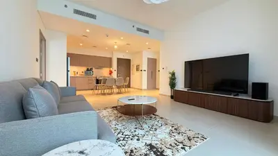 a living room with a couch and a large flat screen tv at Premium 2bed Apartment In Downtown Act1 Tower in Dubai