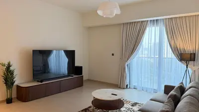 a living room with a couch and a flat screen tv at Premium 2bed Apartment In Downtown Act1 Tower in Dubai